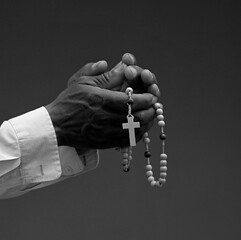 Wall Mural - praying to god with hands together on black background with people stock image stock photo	