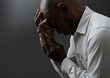 © herlanzer - man praying to god with hands together Caribbean man praying with black grey background with people stock image stock photo