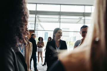 Wall Mural - businesswoman engaging in lively conference discussion highlighting collaboration and networking