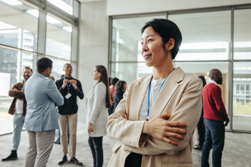 Quiet confidence: Professional woman in office networking with colleagues