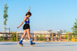 © ADDICTIVE STOCK - Young woman enjoys roller skating in urban park