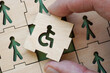 © Vitalii Vodolazskyi - Hand holding puzzle piece with disability symbol. Concept of inclusion in work and society.
