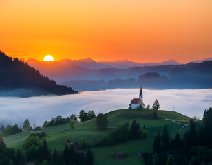 Wall Mural - Landscape with a church on top of a hill and fog in the valley at sunrise