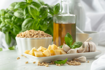 Sticker - Ingredients for making Pesto sauce on a white wooden table.