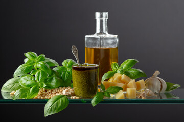 Sticker - Pesto sauce and ingredients on a glass table.