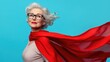 © Hope - Portrait of her she nice attractive strong powerful cheerful cheery glad gray-haired lady wearing red costume super granny on blue background.