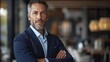 © Рудой Максим - Confident businessman posing indoors in a stylish modern restaurant