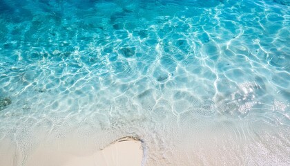 Sticker - sea water waves texture ripples on water surface light blue ocean water top view clear aqua background sun glow reflection white sand bottom stones underwater tropical island beach