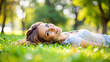 © thanakrit - Beautiful woman lying on the grass in a park.