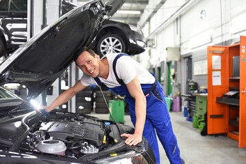 car mechanic in a workshop repairing a vehicle