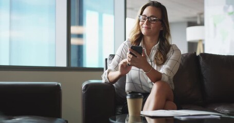 Canvas Print - Cellphone, networking and business woman on sofa browsing on social media, mobile app or internet. Technology, office lounge and professional female creative designer scroll on a phone in workplace.