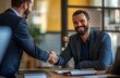 © Sagar - business man and woman shaking hands in an office