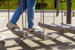 © Tatiana - person navigates a challenging fitness apparatus: swinging logs suspended by metal chains, showcasing balance, strength, and determination in a dynamic outdoor training environment