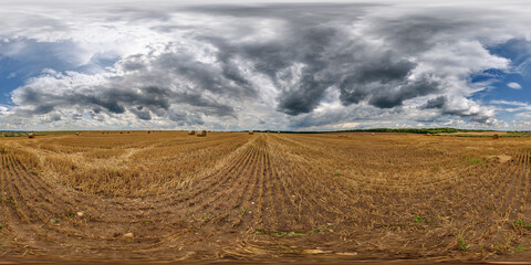 Wall Mural - spherical 360 hdri panorama on rye and wheat fields with hay bales with rain storm clouds in dark sky in equirectangular seamless projection, as skydome replacement in drone panoramas