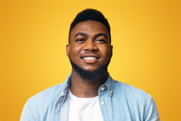 Wall Mural - Be yourself. Closeup portrait of confident black millennial guy over yellow background, copy space