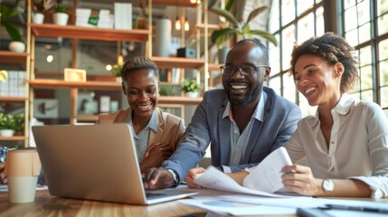 Poster - Three people are sitting around a table with a laptop open in front of them