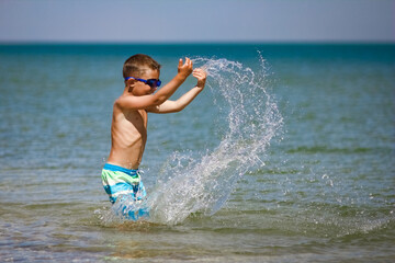 Canvas Print - A Happy child playing in the sea swim in nature