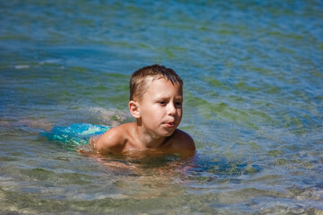 Wall Mural - A Happy child playing in the sea swim in nature