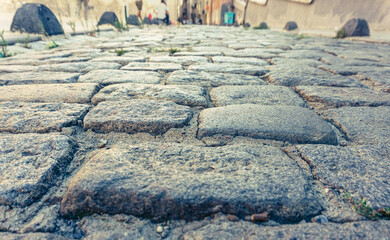 A low-angle shot of a cobblestone path, capturing the texture and detail of the historic street, perfect for urban and architectural themes.