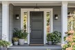 © Elmira - This grey modern farmhouse front door features a covered porch and is adorned with planters and light fixtures for added charm and curb appeal