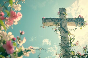 A stunning cross entwined with greenery and colorful flowers reaching towards the sky in a peaceful outdoor setting