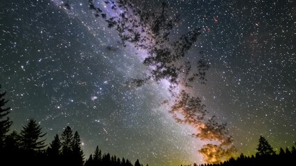 a breathtaking night sky filled with stars and the milky way over a serene mountain landscape. timel