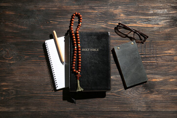 Wall Mural - Holy Bible, notebooks, prayer beads, eyeglasses and pen on wooden background