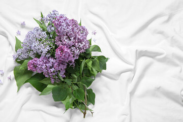 Wall Mural - Bouquet of blooming beautiful lilac flowers on bed