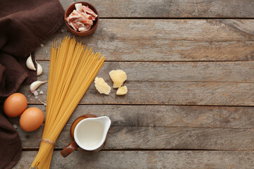 Wall Mural - Ingredients for tasty pasta carbonara on wooden background