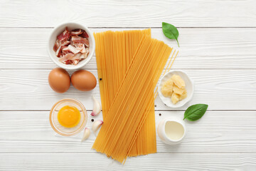 Canvas Print - Ingredients for tasty pasta carbonara on light wooden background