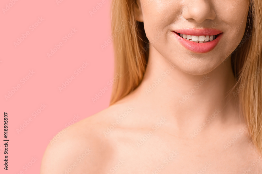 Smiling young woman with beautiful lips on pink background, closeup
