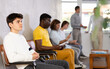 © JackF - Young guy sitting in lobby of job center or employment office, waiting for interview or conversation with career counselor