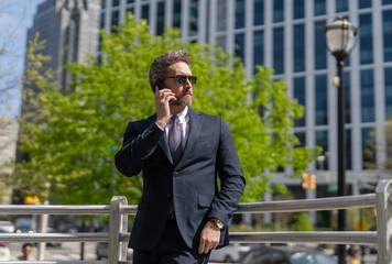 Canvas Print - Business communication. Business man having phone call outdoor. Businessman using phone. Man phone conversation in suit. Middle aged Hispanic businessman with phone. Feedback loop