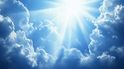 Bright blue sky with the sun's rays and clouds