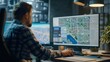 © Palung - A man seated at a desk, analyzing geographic data on a computer with maps displayed on the screen. Maps are visible on the monitor