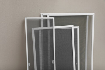 Wall Mural - Set of window screens near beige wall