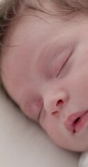 Sticker - Tired, peaceful and newborn sleeping on a bed at a home in the bedroom for resting and dreaming. Cute, sweet and little baby, child or kid taking a nap in the morning in the nursery at family house.