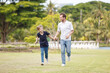 © DG PhotoStock - Man piggyback his son on a shoulder and walking around the park.