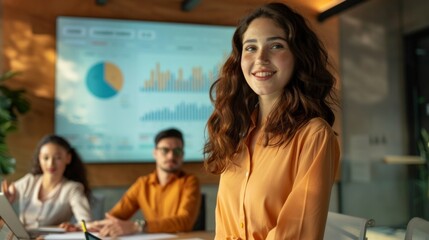 Sticker - A woman in an orange shirt stands in front of a large screen with a group of peo