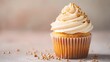 © Sinechana - 4. A deliciously decorated cupcake featuring cream cheese frosting and golden sugar sprinkles, captured on a light background with ample negative space for banner text