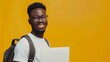 © Generative AI - Confident smiling African American student holding laptop isolated on yellow background copy space Education concept Portrait of happy successful man freelancer looking at camera : Generative AI