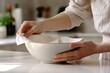 © TuruMuru - Close up of woman wiping bowl in kitchen with paper towel
