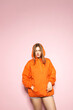 © Alex - Woman Posing, Orange Hoodie on Pink Background