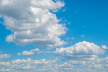 Wall Mural - Background with cumulus clouds in summer. Panorama with light blue sky with white clouds.