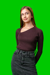 Wall Mural - Young Woman In Maroon Sweater And Denim Skirt Posing In Front Of A Green Screen