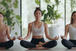 © SITI - Group of Women Practicing Yoga Meditation in a Calm Studio with Natural Light and Greenery