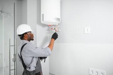 Poster - African american worker set up gas heating boiler at home