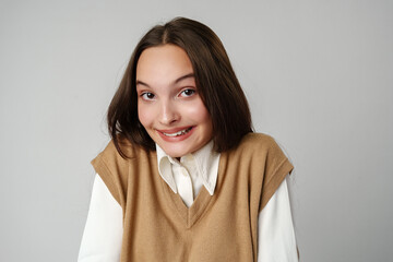 Wall Mural - Photo of young shy adorable lady hold hands against gray background