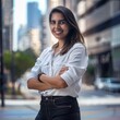 © Olya Fedorova - A young, pretty, purposeful girl in business clothes stands and smiles against the background of the street