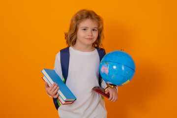 Aufkleber - Back to school. School kid portrait. Schoolboy with world globe and book. School child student with backpack. Elementary school child. Portrait of pupil on yellow studio isolated background.
